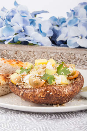 Delicious Portobello mushroom stuffed with vegetables.の写真素材