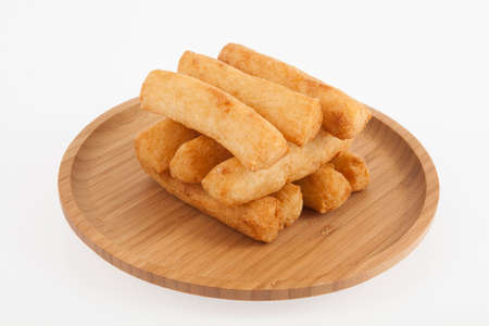 Tasty fried cassava sticks; photo on white background.
