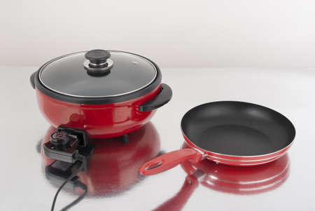 Antiaderente red electric skillet and pan.の写真素材