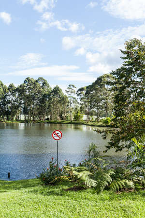 Lake with prohibited sign swimming.の写真素材