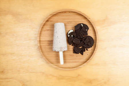 Ice cream - tasty and refreshing flavored cookies and cream, photo on wooden background.の写真素材