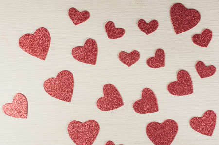Red hearts on wooden background.