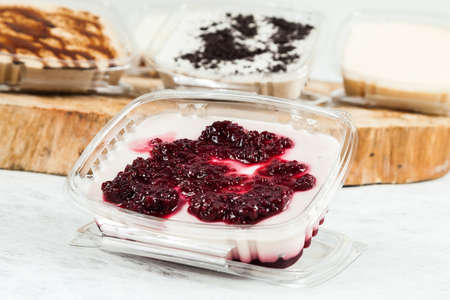 Panna cotta - tasty dessert with blackberry sauce.