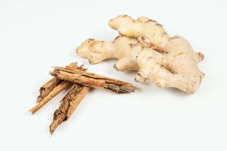 Ginger root and cinnamon ; photo on neutral background.