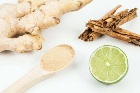 Ginger root with lemon and cinnamon photo on neutral background.