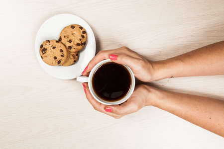 Woman Hands With Cup Of Coffee With Cookies.の写真素材
