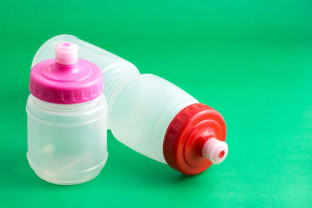 plastic sports bottles with a lid to store and transport liquids for drinking.の写真素材