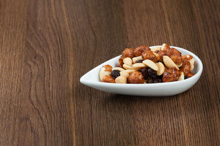 Healthy And Tasty Snack; Mixture of peanuts, raisins, and peanuts Covered With Honey.の写真素材