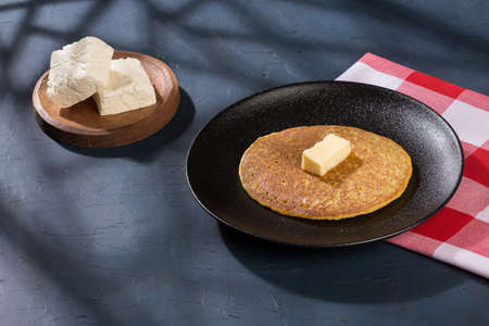 Typical food in Colombia - tasty arepa de choclo with butter and cheese.