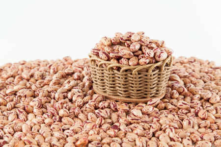 Pinto beans, a legume native to the American continent; photo on white background.