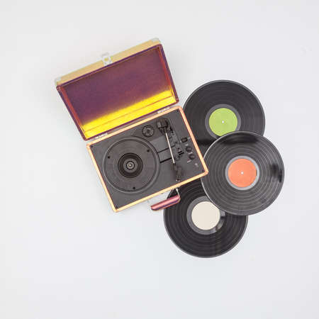 Old vinyl turntable player with record isolated on a white background.
