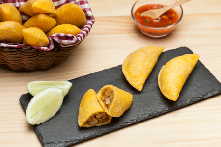 Tasty empanadas - Colombian cuisine; photo on wooden background