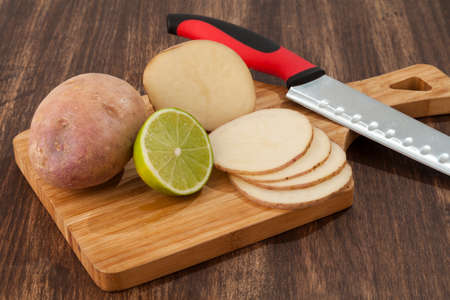 Preparation Sliced Potatoes With Lemon; Photo On Wooden Backgroundの写真素材