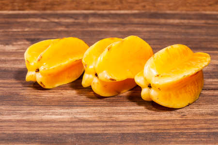 Averrhoa Carambolo - Star Fruit Or Carambola; Photo On Wooden Backgroundの写真素材