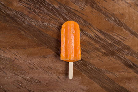 Tasty And Refreshing Orange Flavor ice cream; On Wooden Backgroundの写真素材