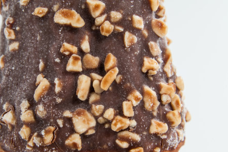 ice cream with chocolate coating and pieces of peanuts