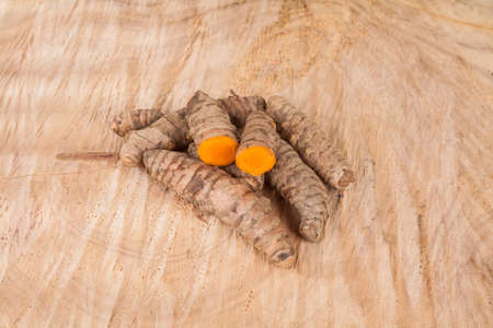 Roots of turmeric (Curcuma longa); Photo on wooden background.の写真素材