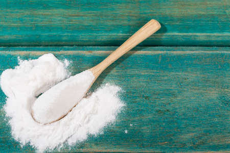 Spoon Of With Baking Soda; Photo On Wood Background