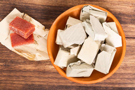 Guava Paste Wrapped in Bijao Leaf; Photo On Wood Backgroundの写真素材