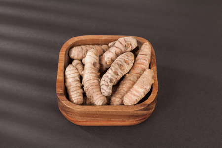 Roots of turmeric (Curcuma longa) Photo on dark background.