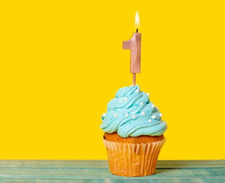 Birthday Cake With Candle Number 1 - On Yellow Background.の写真素材