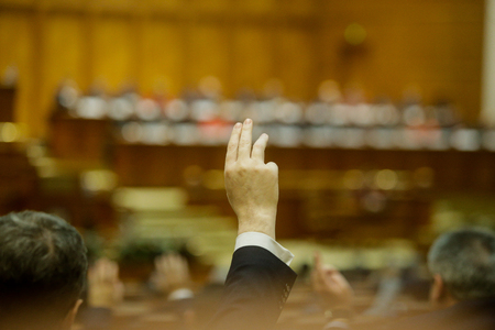 Members of Romanian Parliament voting by raising their handsの写真素材
