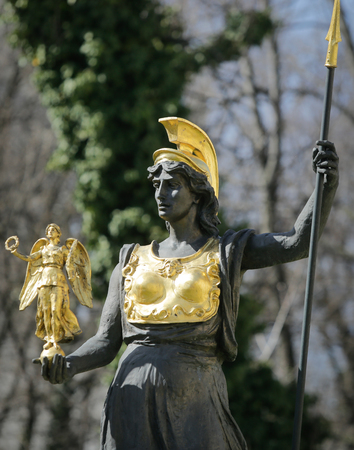 Golden plated statue of Athena/Minerva holding Nike (Victory) in her handの写真素材