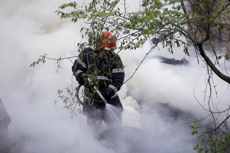BUCHAREST, ROMANIA - APRIL 17: Firefighters try to extinguish with water a fire that spread across an uninhabited house, on April 17, 2017, in Bucharestのeditorial素材