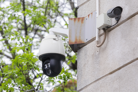 Surveillance cameras on the exterior wall of a building
