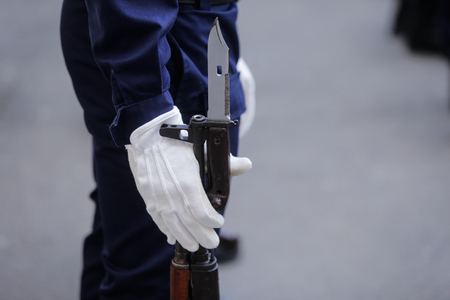 Close-up of a soldier waiting with his bayonet rifle on the groundの写真素材