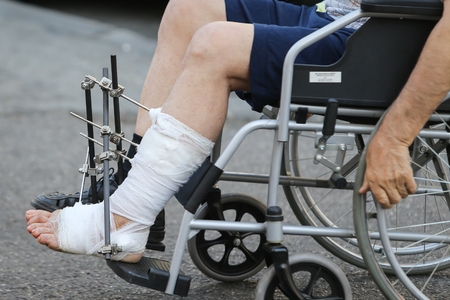 Man nurse pushing an empty wheelchair at an emergency hospitalの写真素材