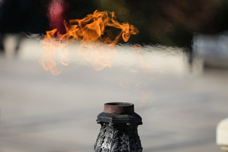 Eternal flame for the heroes at the monument in the memory of fallen soldiers during World War Two, in Bucharest, Romaniaの写真素材