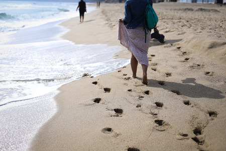 Woman walking on the beach at the Black Sea coastlineの写真素材