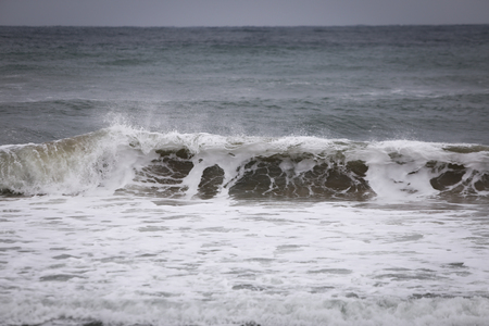 Black sea waters on the coastline of Bulgaria, in a cloudy late autumn dayの写真素材