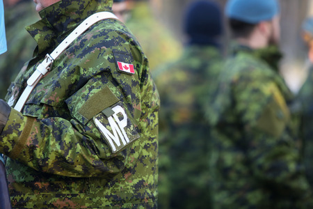 Bucharest, Romania - December 1, 2018: Details with the uniform and flag of Canadian Military Police soldiers taking part at the Romanian National Day military parade.のeditorial素材
