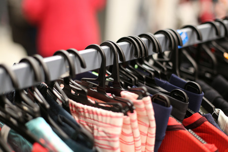Details with clothes on hangers in a clothing store inside a shopping mallの写真素材