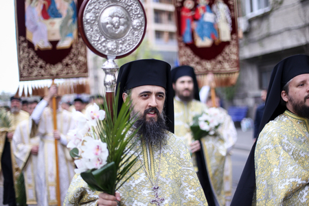 Bucharest, Romania - April 20, 2019: Romanian Orthodox priests during a Palm Sunday pilgrimage...