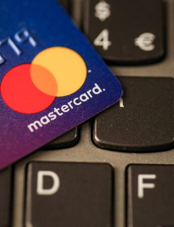 Bucharest, Romania - May 14, 2019: Macro image with the details of a Mastercard plastic credit card with the Mastercard logo on a laptop keyboard - online payment.のeditorial素材
