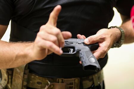 Bucharest, Romania - June 10, 2019: Details with the hands of a soldier handling a 9mm caliber Beretta PX4 Storm pistolのeditorial素材