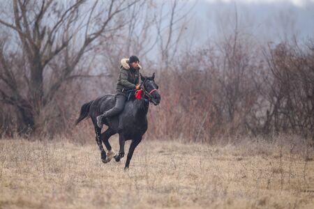 Pietrosani, Romania - January 6, 2019: Man is bareback riding an adorned horse before an Epiphany celebration horse race.のeditorial素材