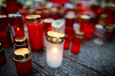 Shallow depth of field image with details of candles put on the pavement by peopleの写真素材