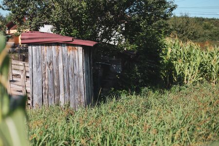Wooden outdoor toilet in a village in rural Romaniaの写真素材