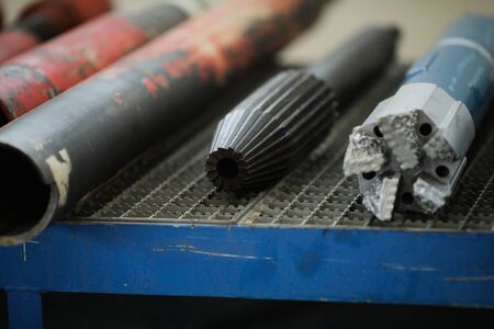 Details with the old and rusty heavy iron drill heads used in the oil and gas industry
