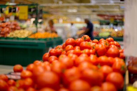 Shallow depth of field image with tomatoes on the fruits and vegetables aisle in a storeの写真素材