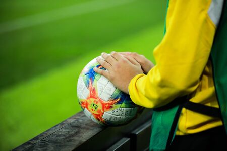 Bucharest, Romania - October 15, 2019: Details with the hands of a boy on an Adidas Conext 19 European qualifiers official soccer match ball on Arena Nationala stadium.のeditorial素材