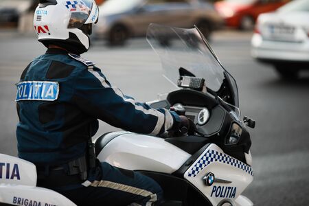 Bucharest, Romania - October 19, 2019: Police officer riding a BMW motorcycle in the Bucharest city traffic.のeditorial素材