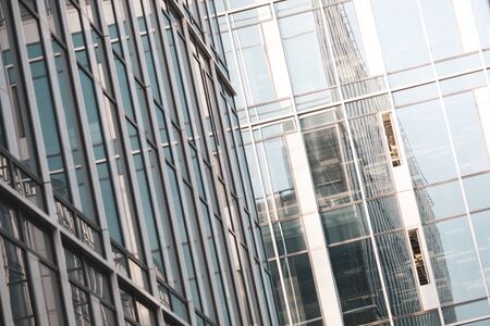 Details with the windows and glass walls and reflections in them of an office/business modern...