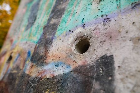 Bucharest, Romania - November 7, 2019: Details of a piece of concrete from the Berlin wall on display in Bucharest, as a symbol of anti communist revolutions in Europe during 1989.のeditorial素材