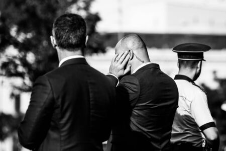 Shallow depth of field (selective focus) image with the coiled tube earpiece a Protection and Guard Service (SPP, Romanian version of the US Secret Service) officer is wearing during a public visit of a dignitary.の写真素材