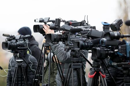 Shallow depth of field image with television video cameras and recording equipment during a press eventの写真素材